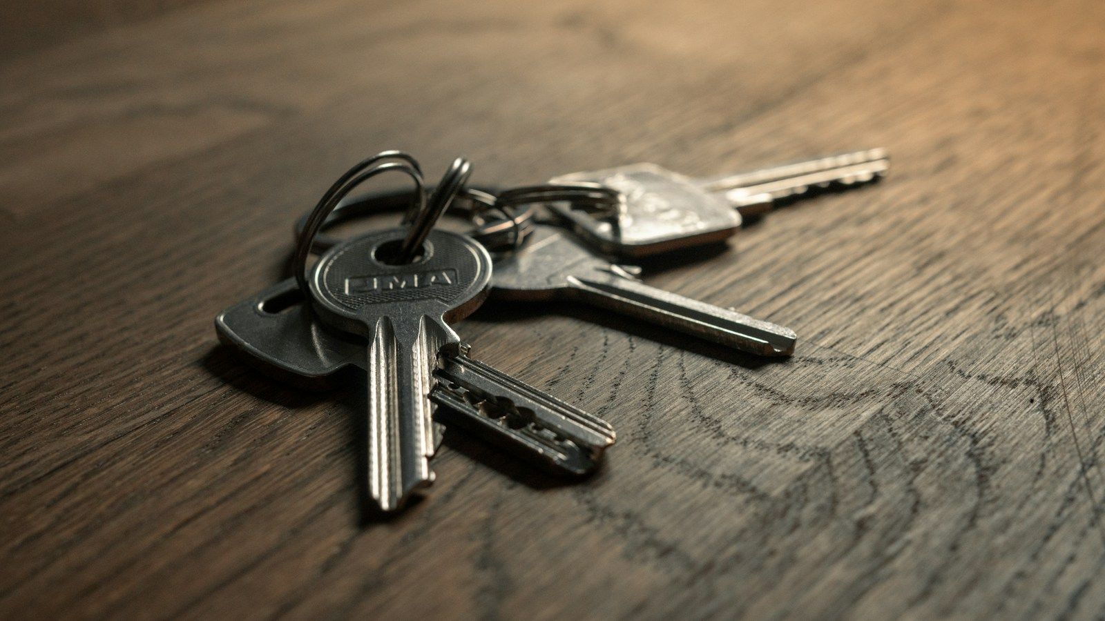 Set of house keys on a wooden table